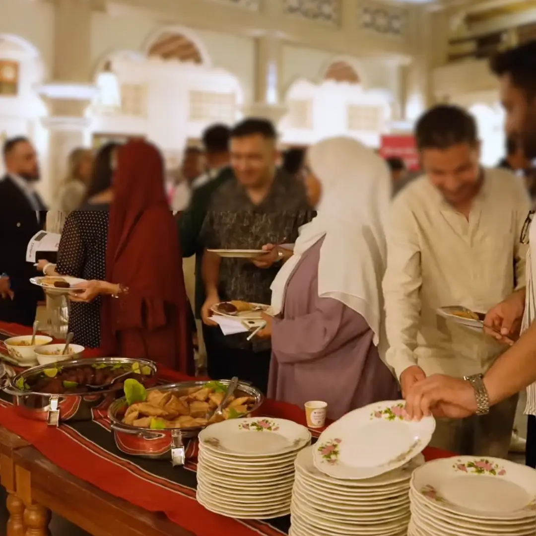 Guests serving food at a Ramadan iftar community event in Dubai organized for PR and collaboration campaign.